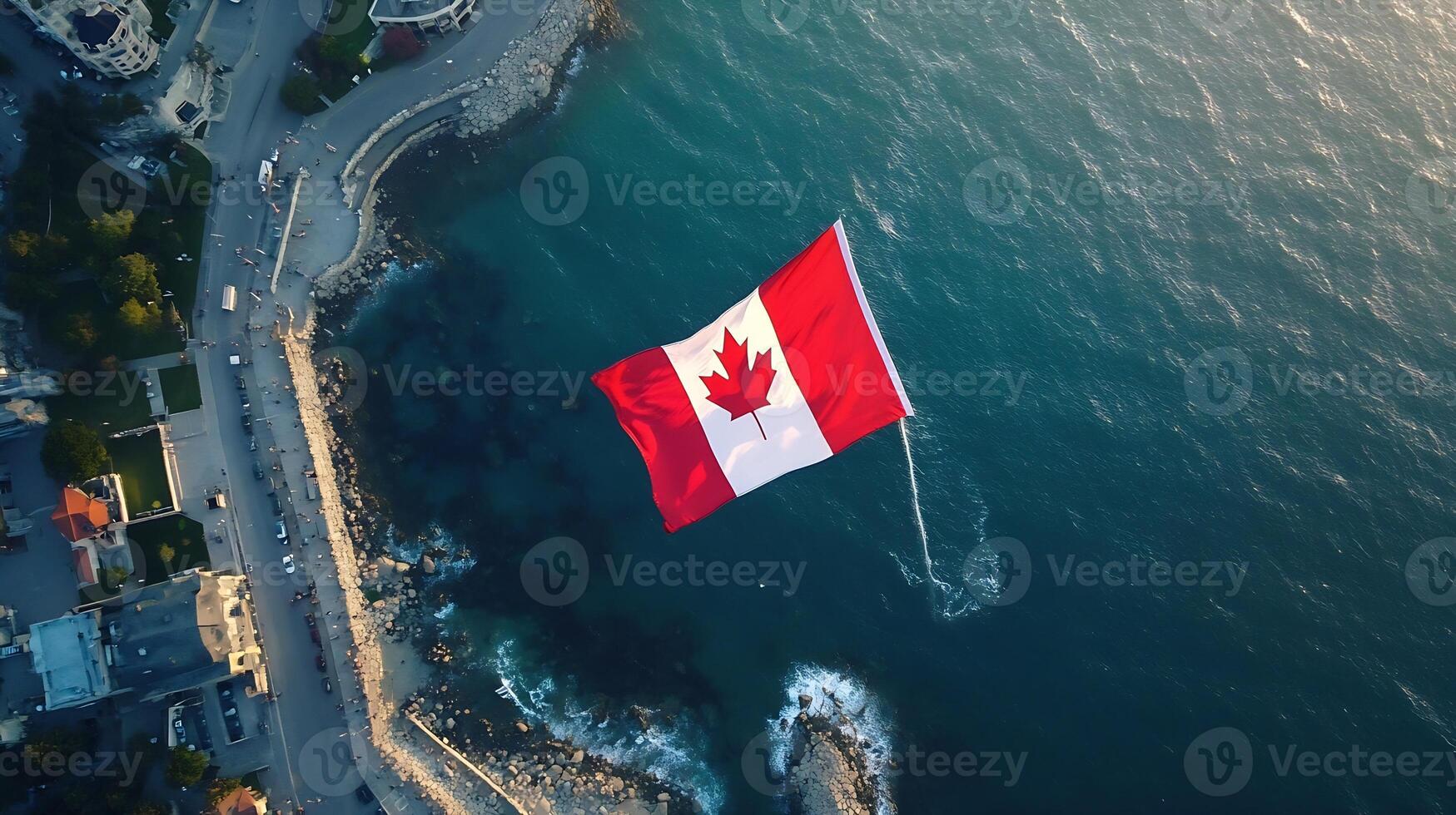 Aerial View of Canadian Flag Flying Above Stunning Coastal Landscape photo
