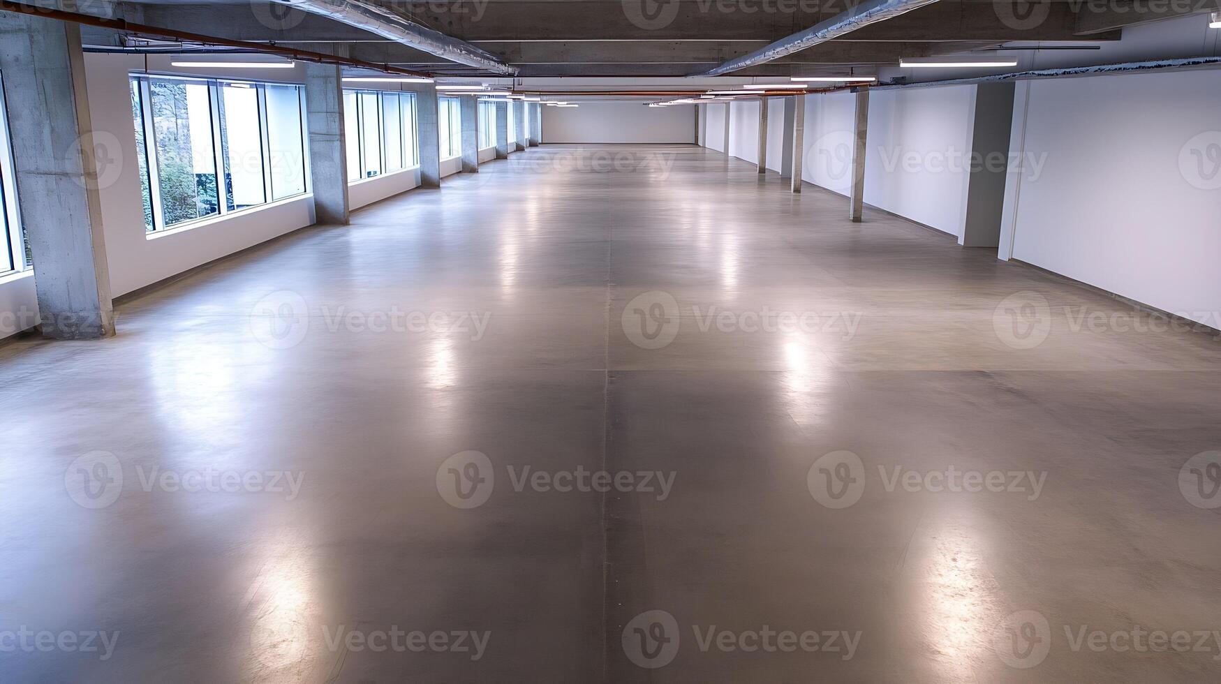 Spacious Empty Warehouse Interior with Polished Concrete Floor and Large Windows photo