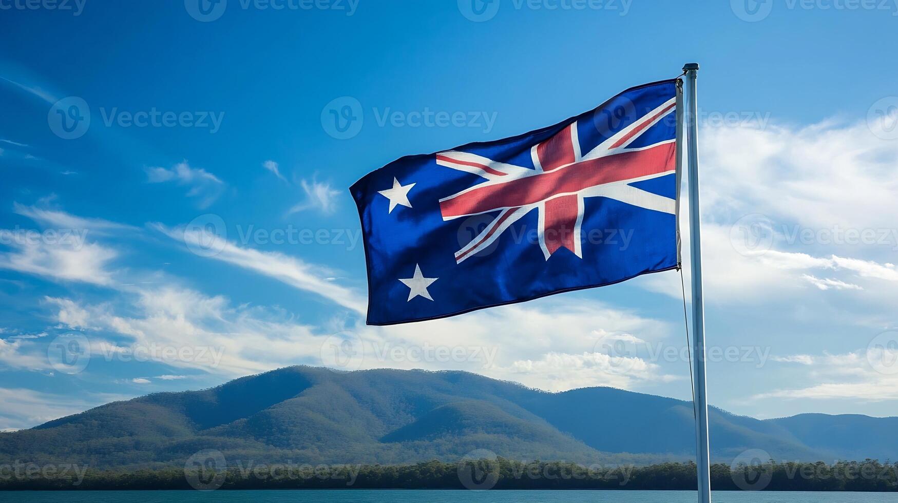 Australian National Flag Billowing Against a Majestic Mountainous Landscape photo
