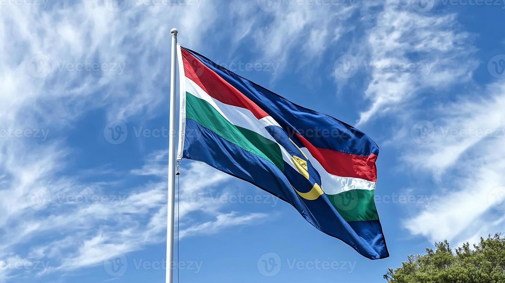 South Africa Flag Waving Under a Clear Blue Sky with Natural Scenery photo
