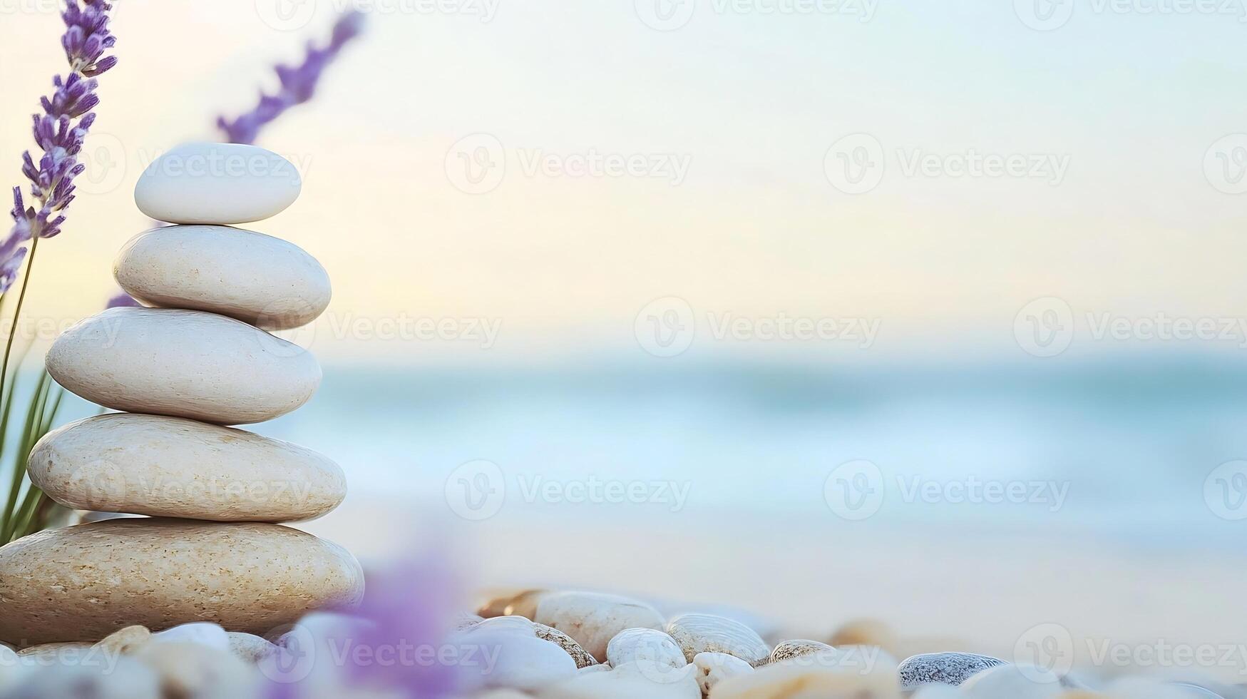 Zen Garden with Stacked Stones and Lavender Flowers by the Ocean Creating a Serene Atmosphere photo