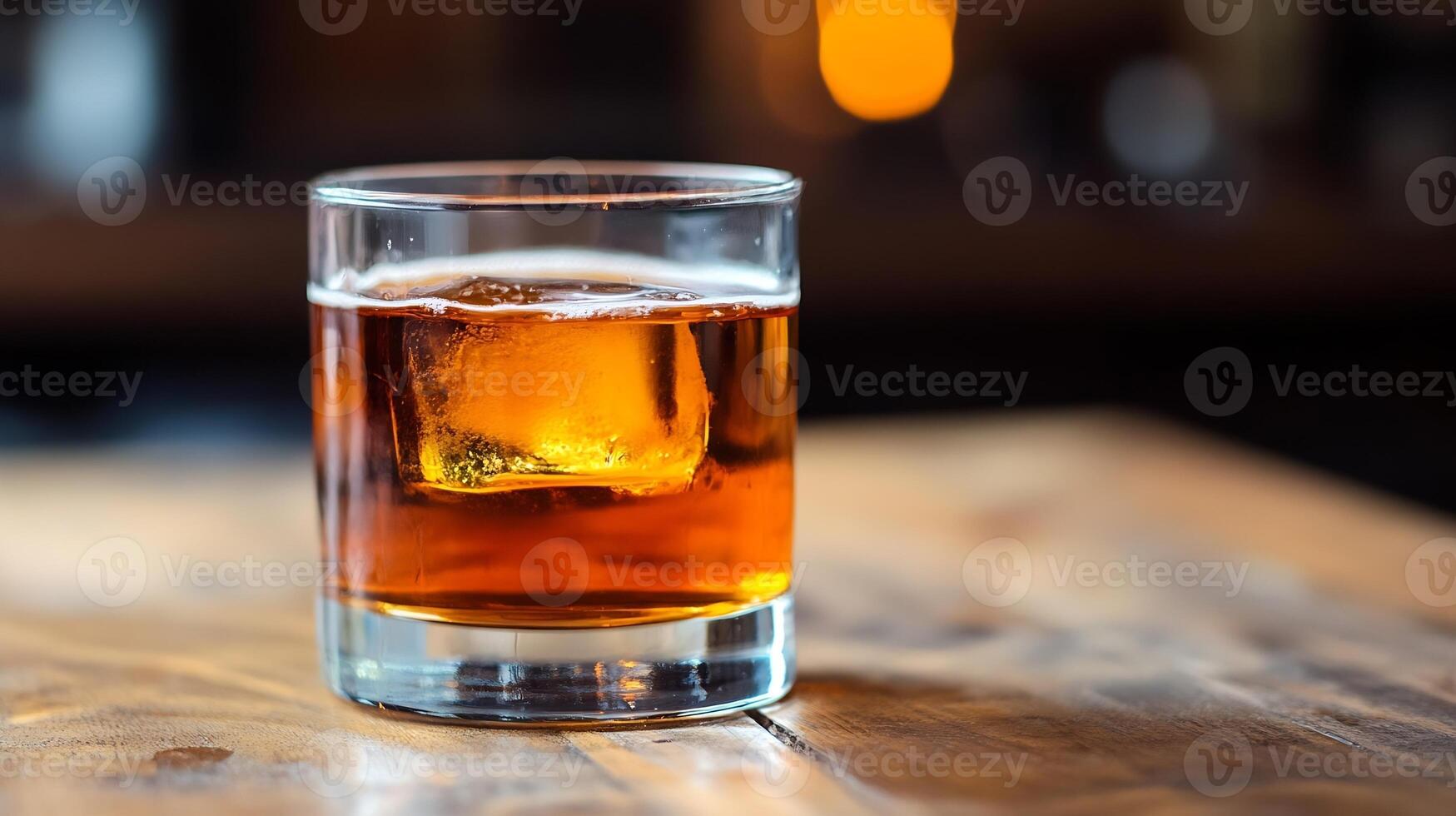 Elegant Glass of Whiskey with Ice Cube on Wooden Table Setting for a Classic Drink Experience photo