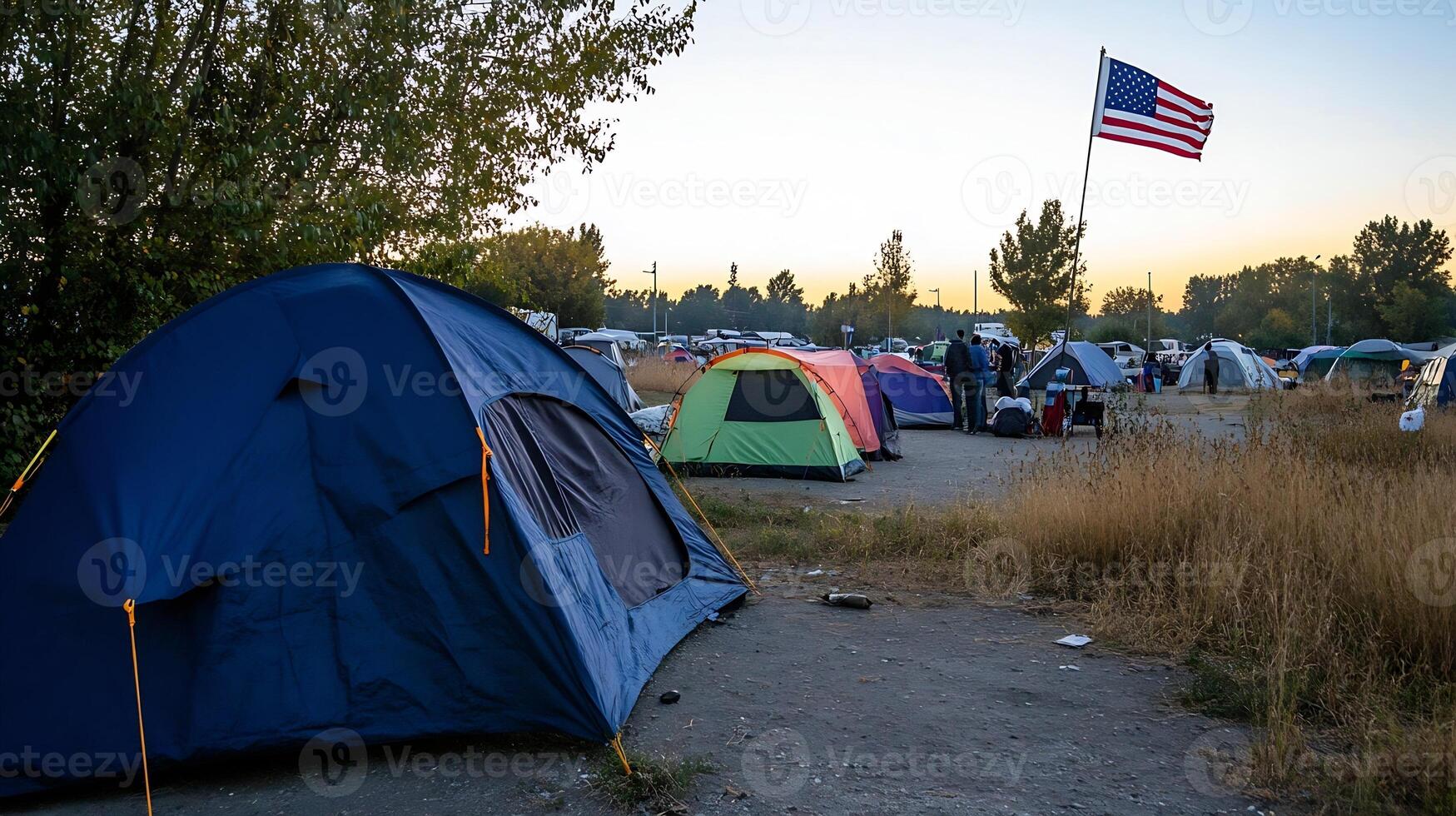 Scenic Camping Site with Multi-colored Tents Under American Flag at Sunset photo