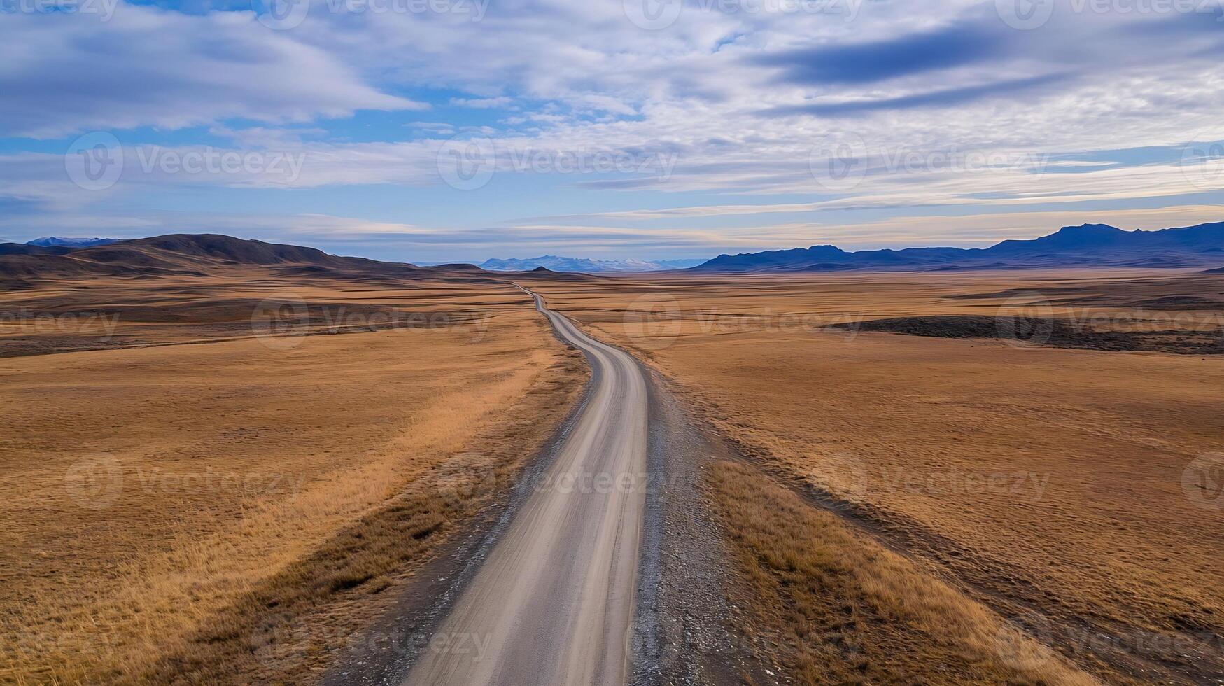 Vast Open Desert Landscape with Distant Mountains Under a Dramatic Sky photo