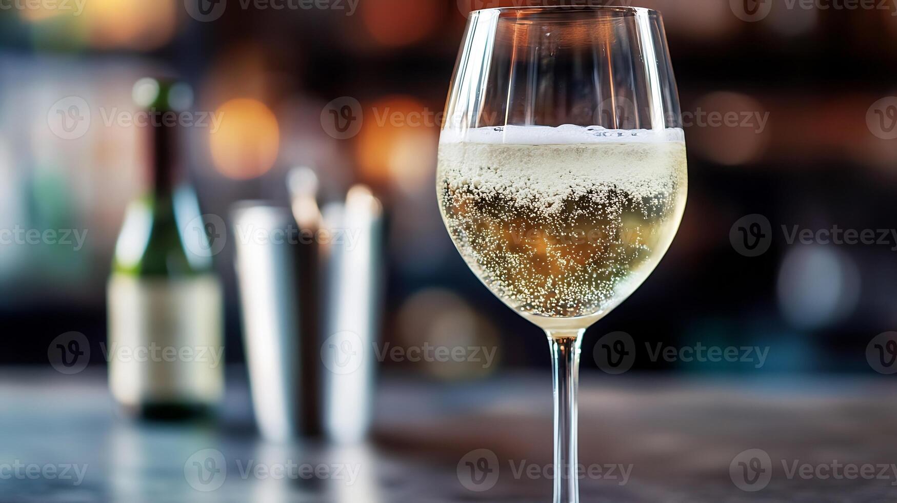 Closeup of sparkling white wine in a glass with blurred background photo