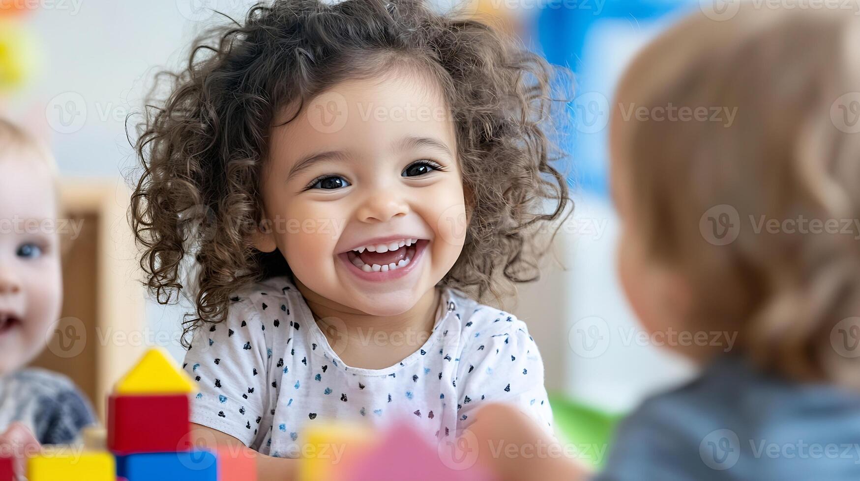 Smiling Toddler with Curly Hair in a Happy Group Playtime Setting photo