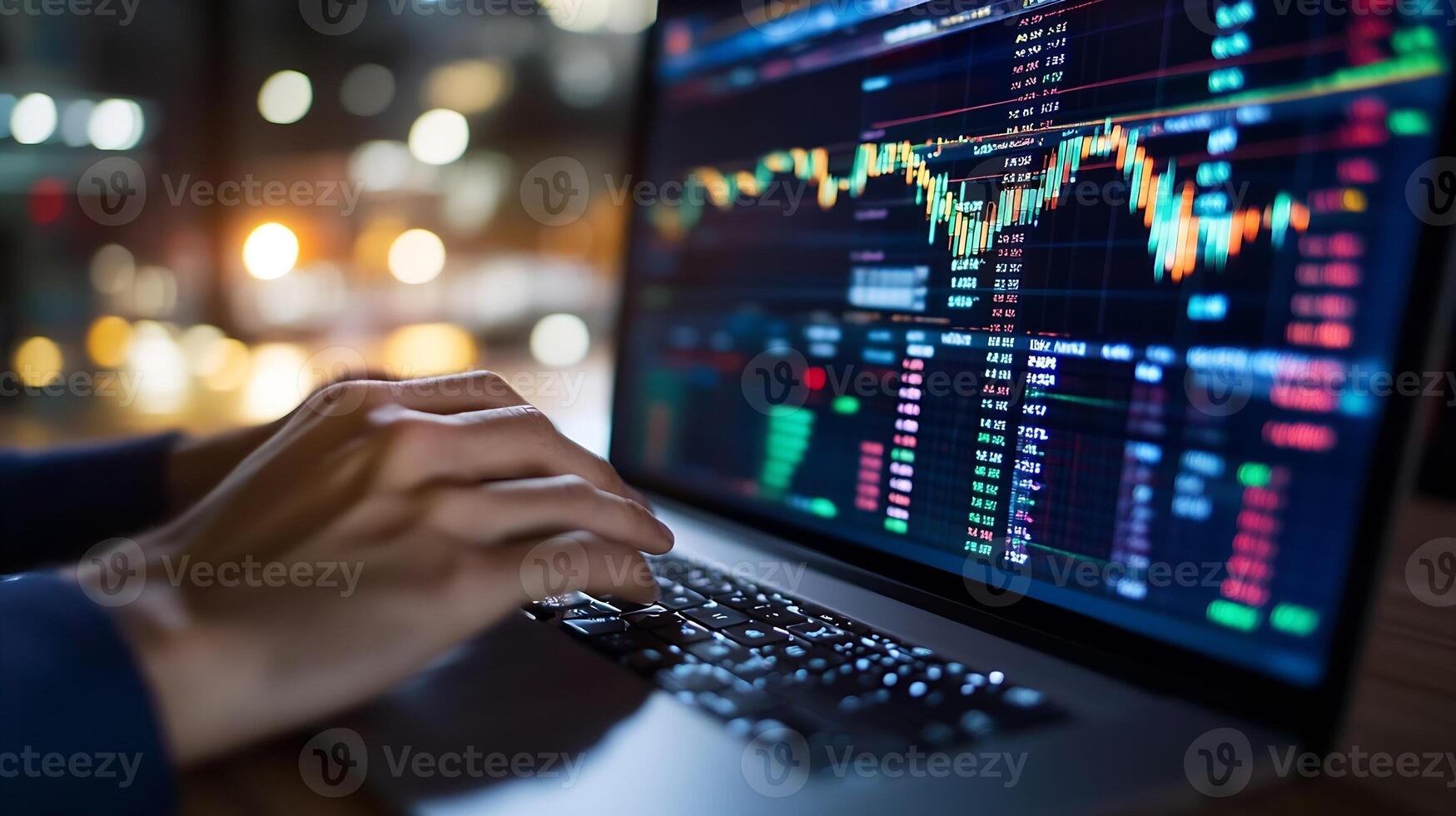 Person Typing on Laptop with Stock Market Charts and Data Displayed on Screen photo