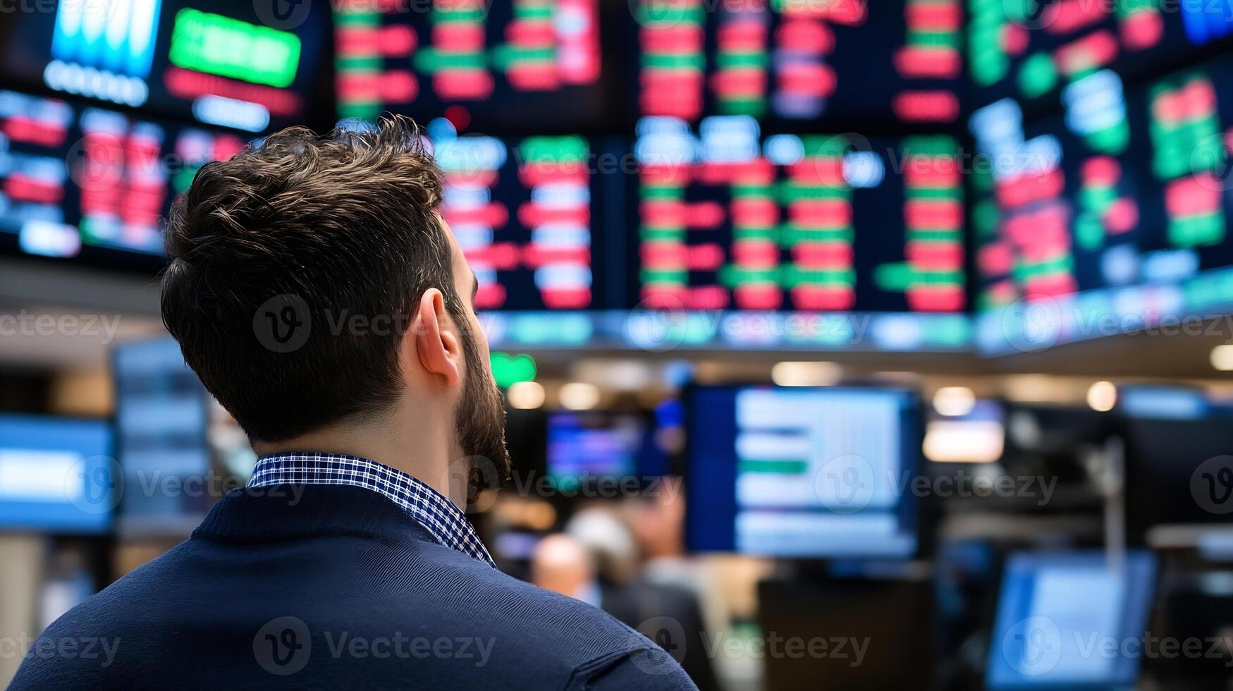 Stock Market Trader Observing Activity on Electronic Trading Board photo