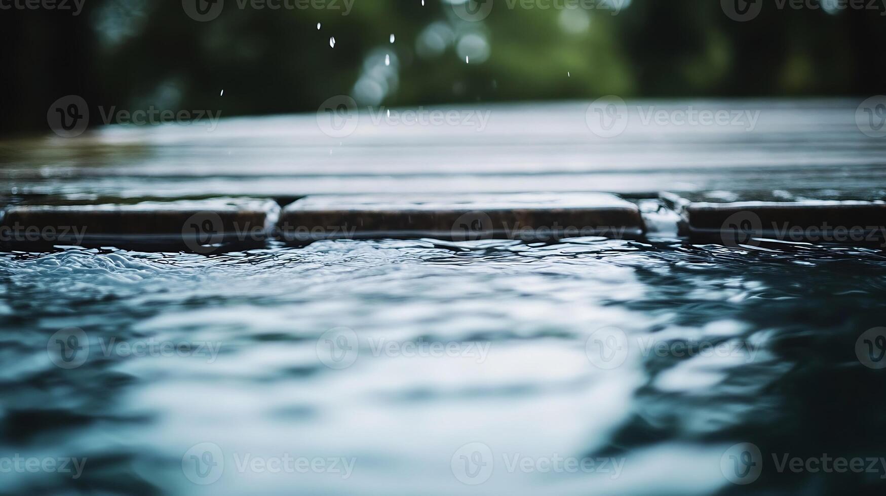 Calm water surface with raindrops creating ripples on wooden deck background photo