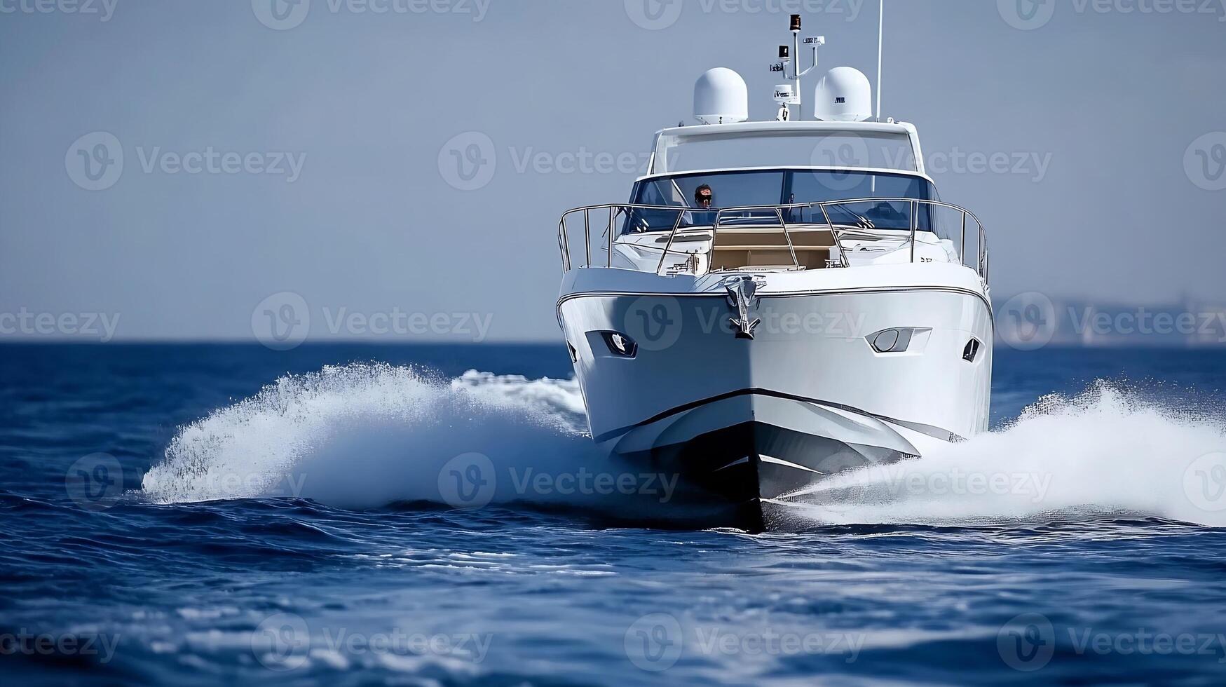 Luxury Yacht Speeding Across Open Ocean With Clear Blue Sky and Splashes of Water photo
