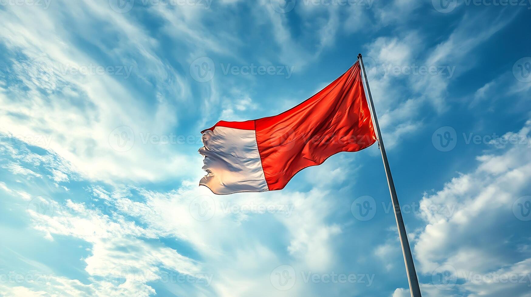 Vibrant Red and White Flag Waving Majestically Against Expansive Sky photo