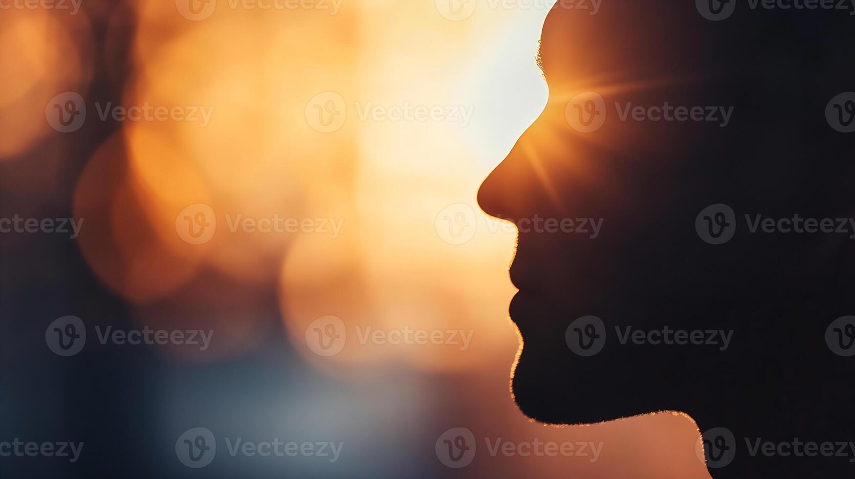 Silhouette of Man with Sunburst in Warm Abstract Background photo