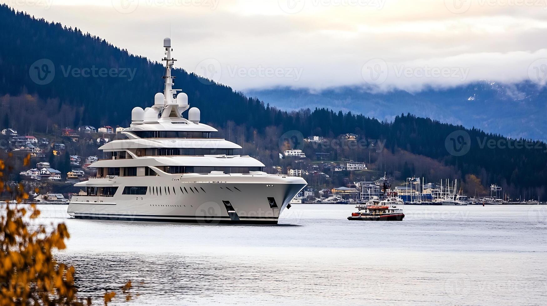 Majestic Superyacht and Small Tugboat on Misty Lake with Mountain Backdrop photo