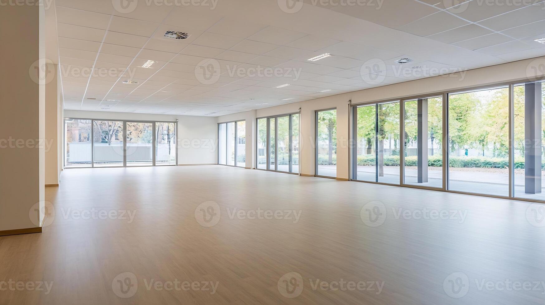 Spacious Empty Room with Hardwood Floors and Large Windows Overlooking Trees photo