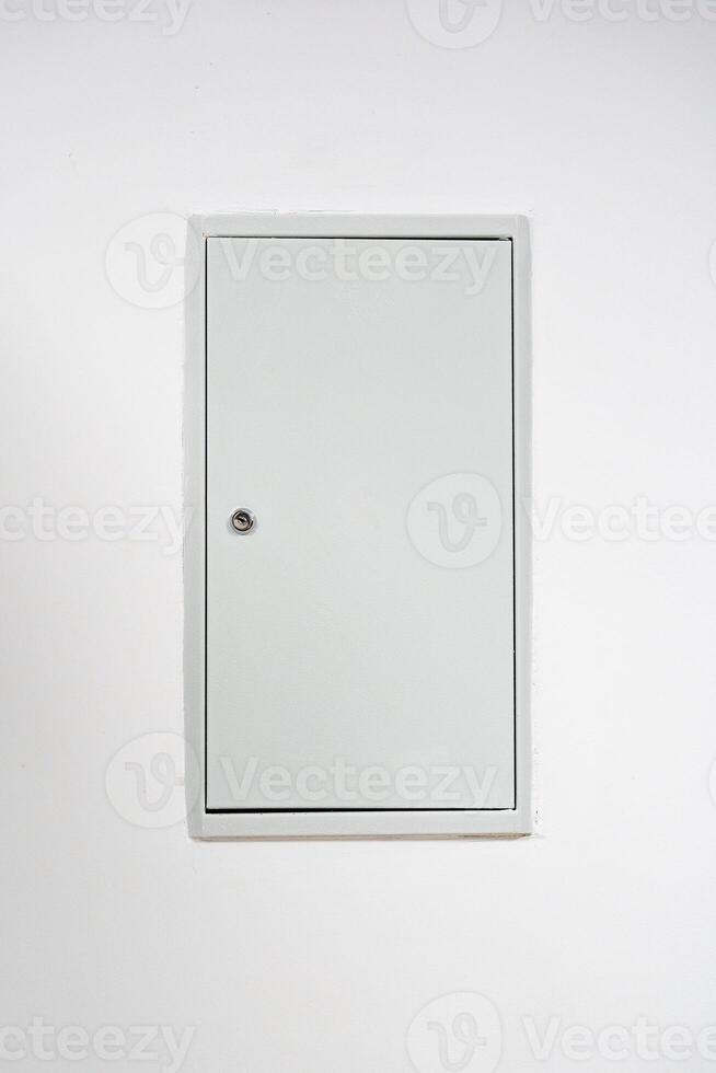 Door with a simple design against a white wall in a minimalistic setting photo