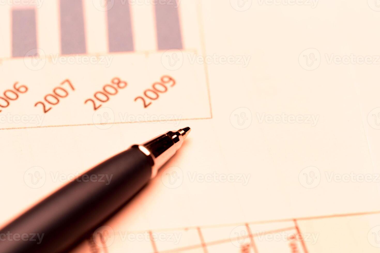 Business charts and pen photo