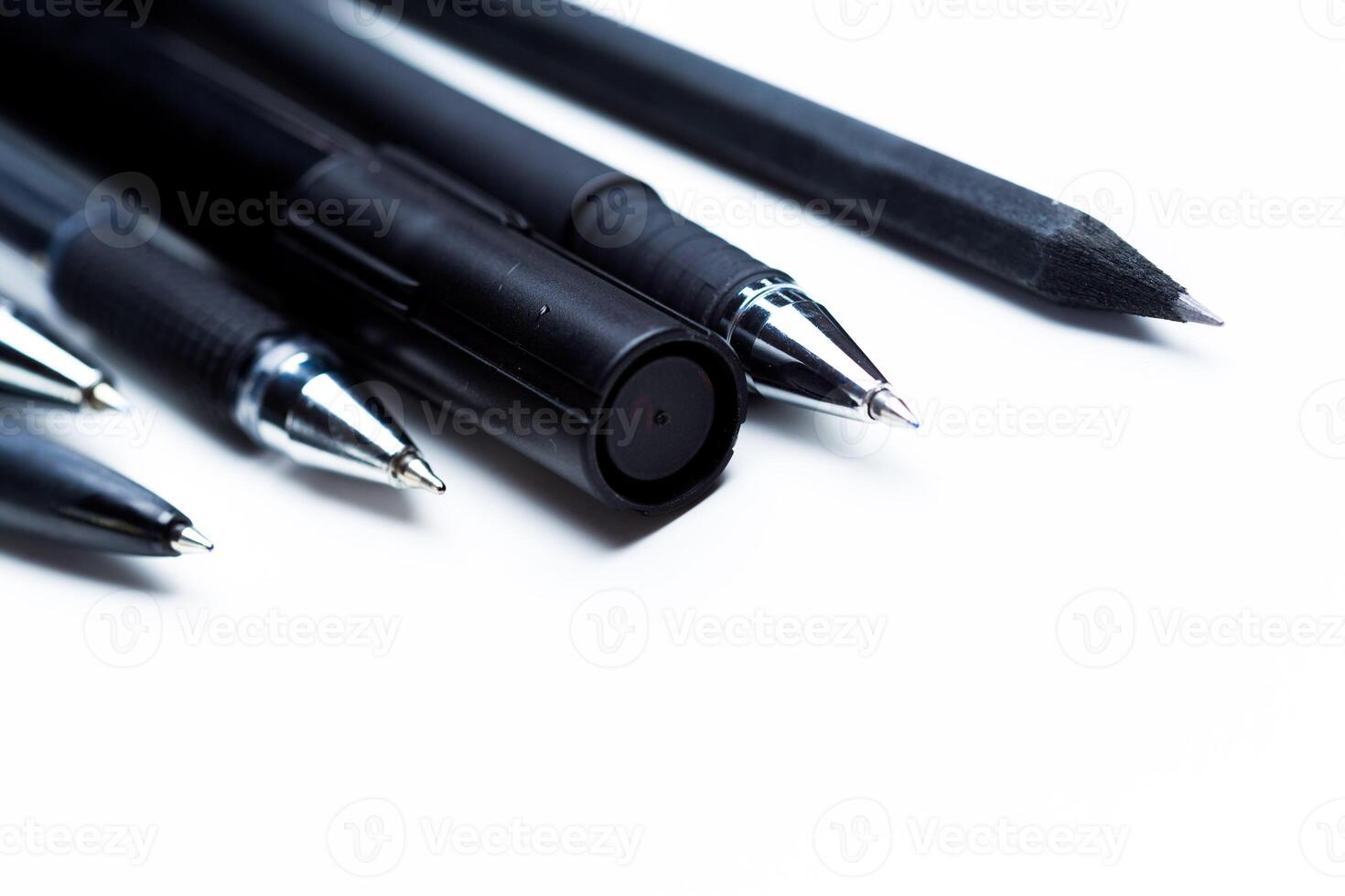 Pens and pencils on white background photo