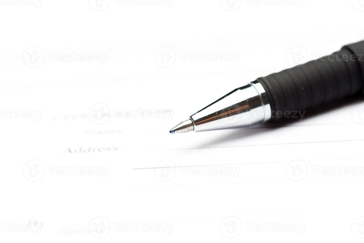Close-up of pen on contract photo