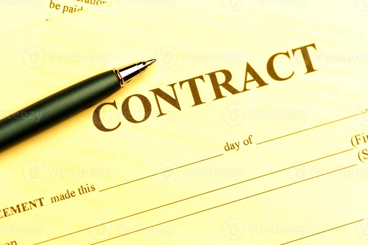 Close-up of pen on contract photo