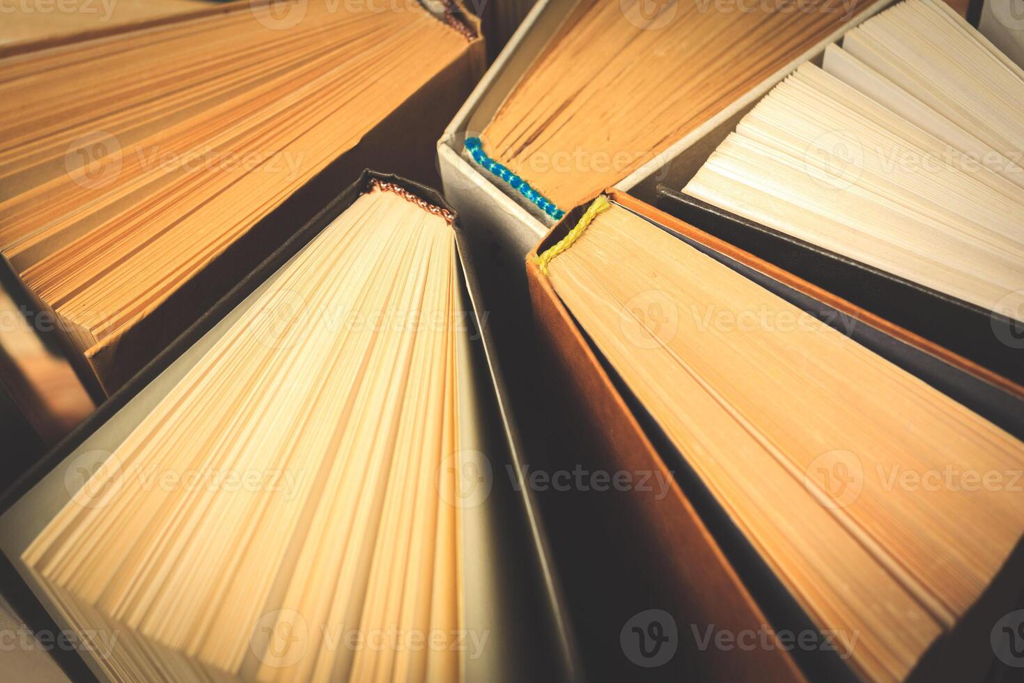 Old and used hardback books or text books seen from above. photo