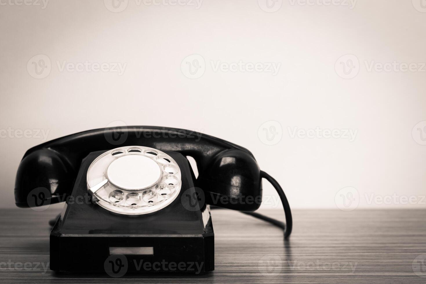 Retro telephone on table photo