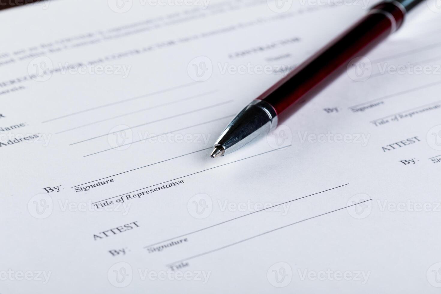 Pen and contract papers on wooden desk photo