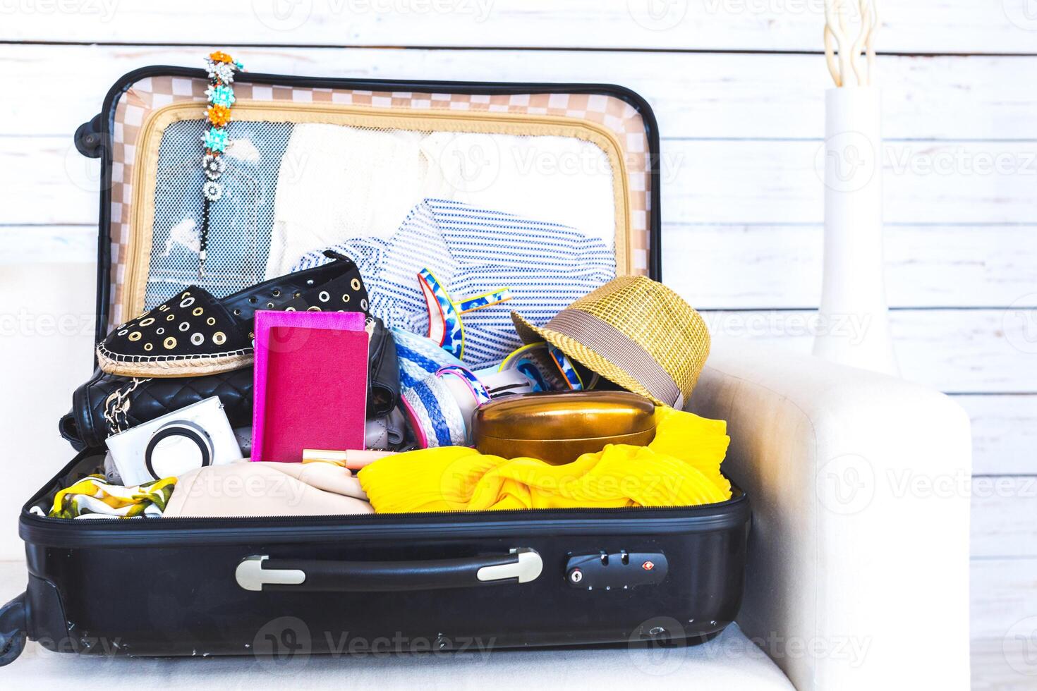 Packed suitcase of vacation items photo