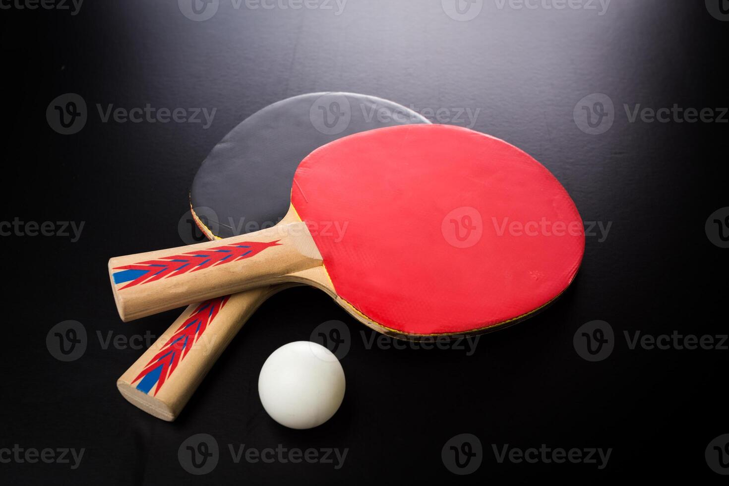 tabletennis racket and ball on table photo