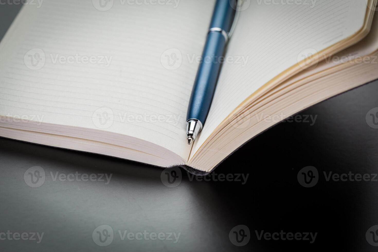 blank notebook and pen on the table photo