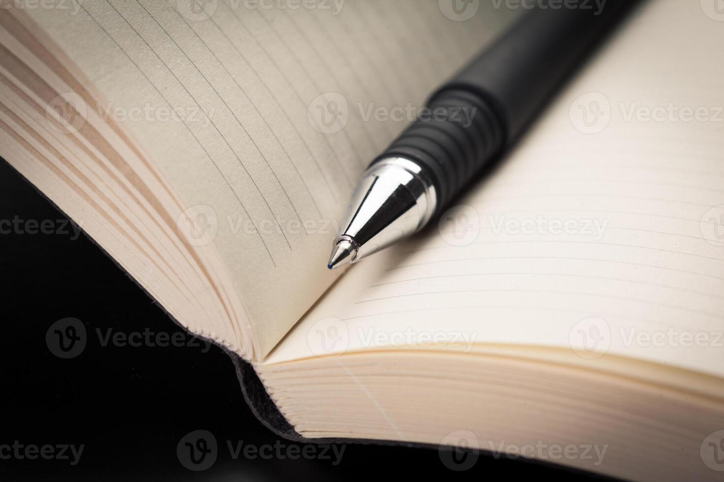 blank notebook and pen on the table photo