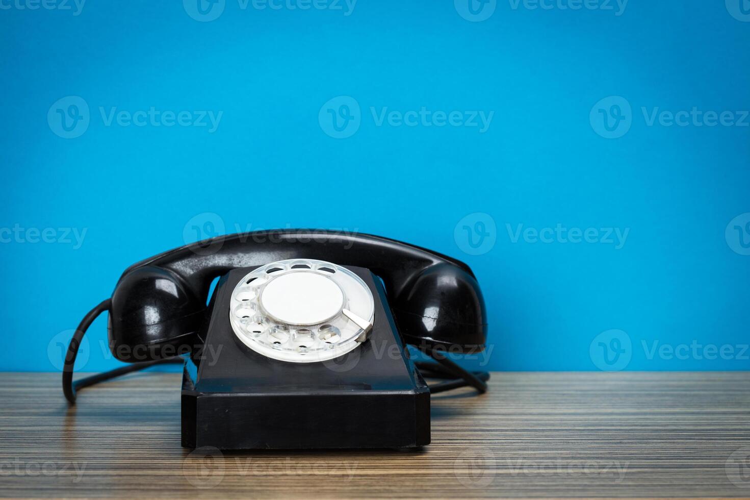 Retro telephone on table photo