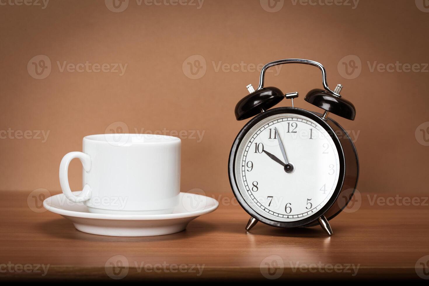 Retro alarm clock on a table. photo