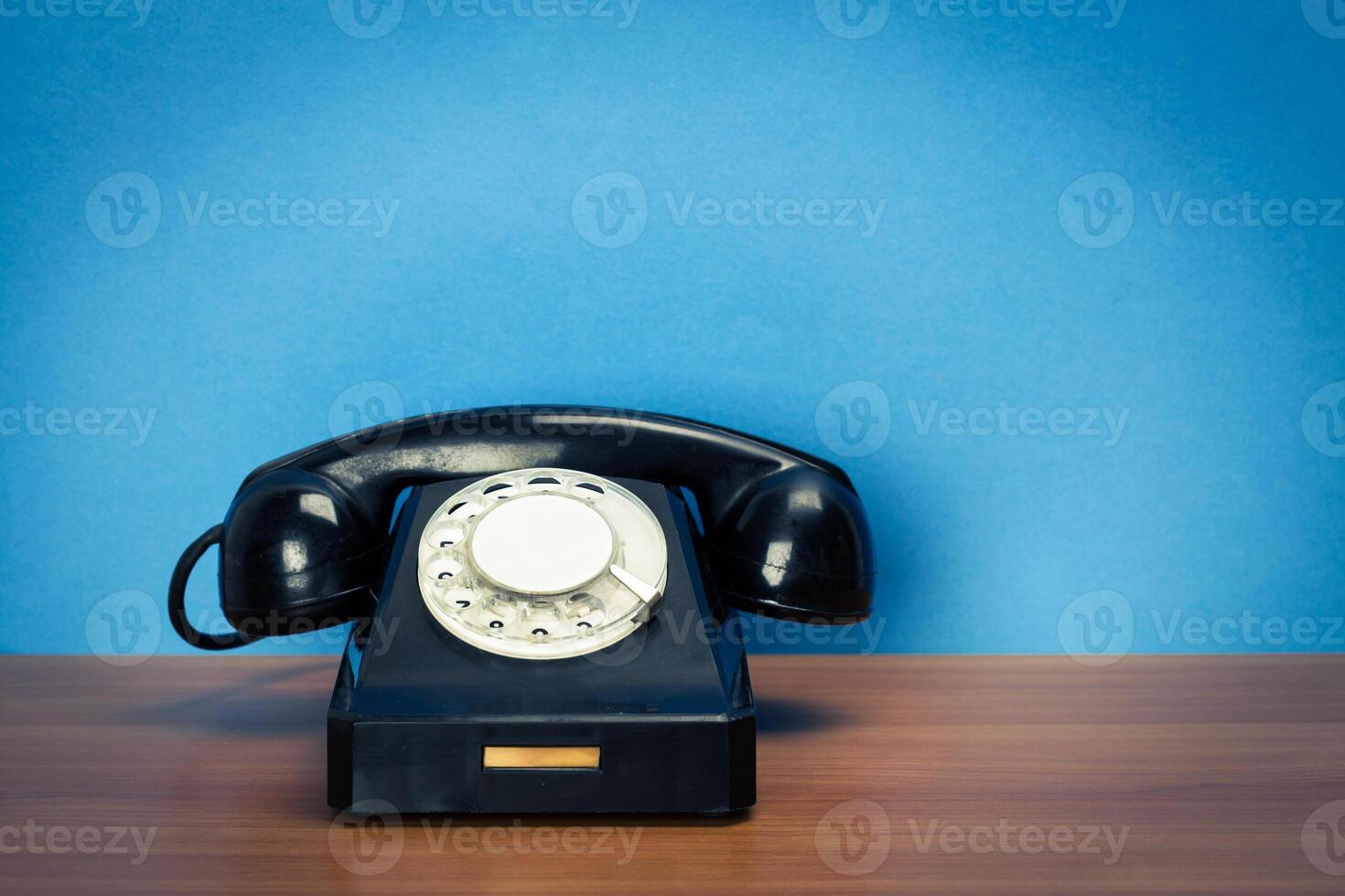 Retro telephone on table photo