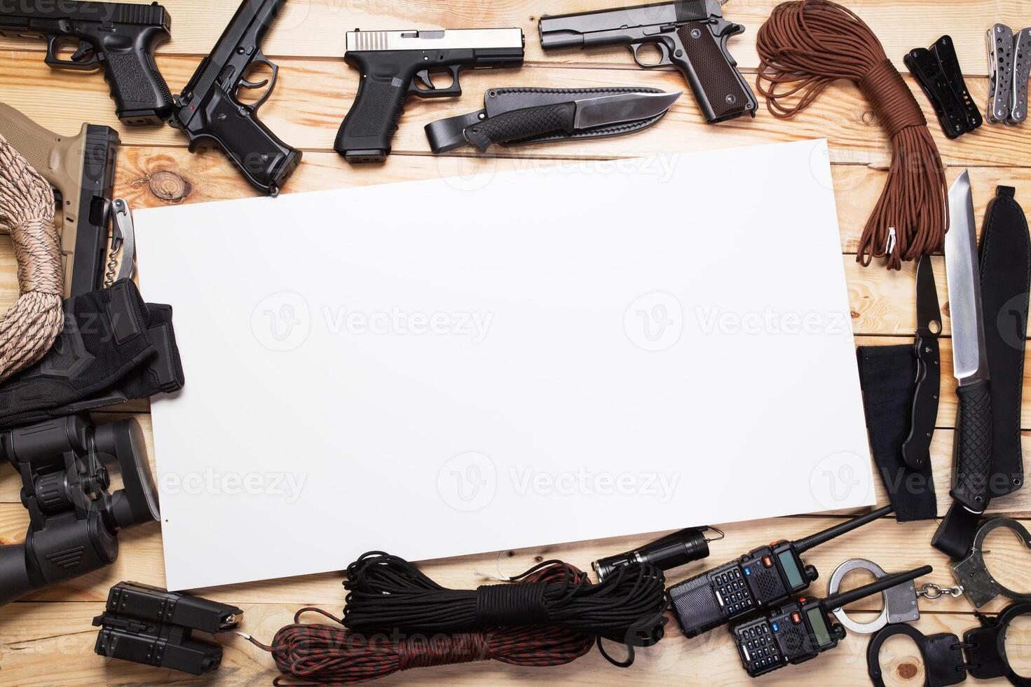 gun,military knife and compass on the wooden table photo