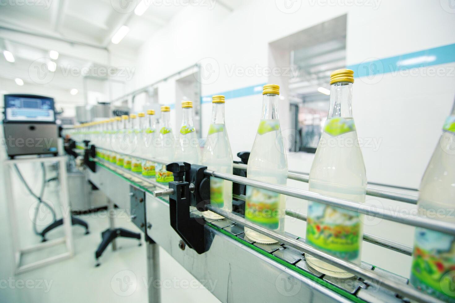 Bottled beverage production in a modern factory setting with a focus on conveyor line operations photo