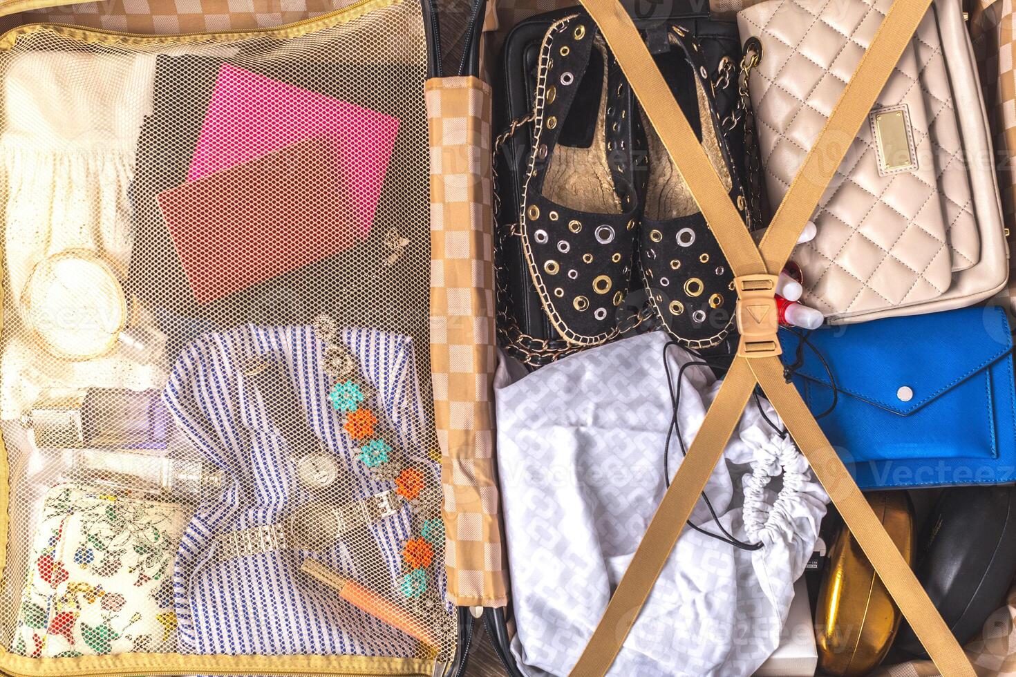 Packed suitcase of vacation items photo