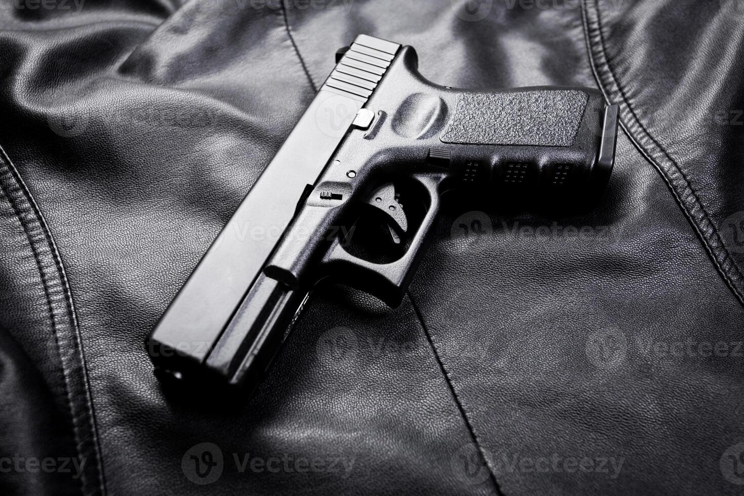 Rifle, gun, knife with sheath, compass and notebook with pen on on black cloth photo