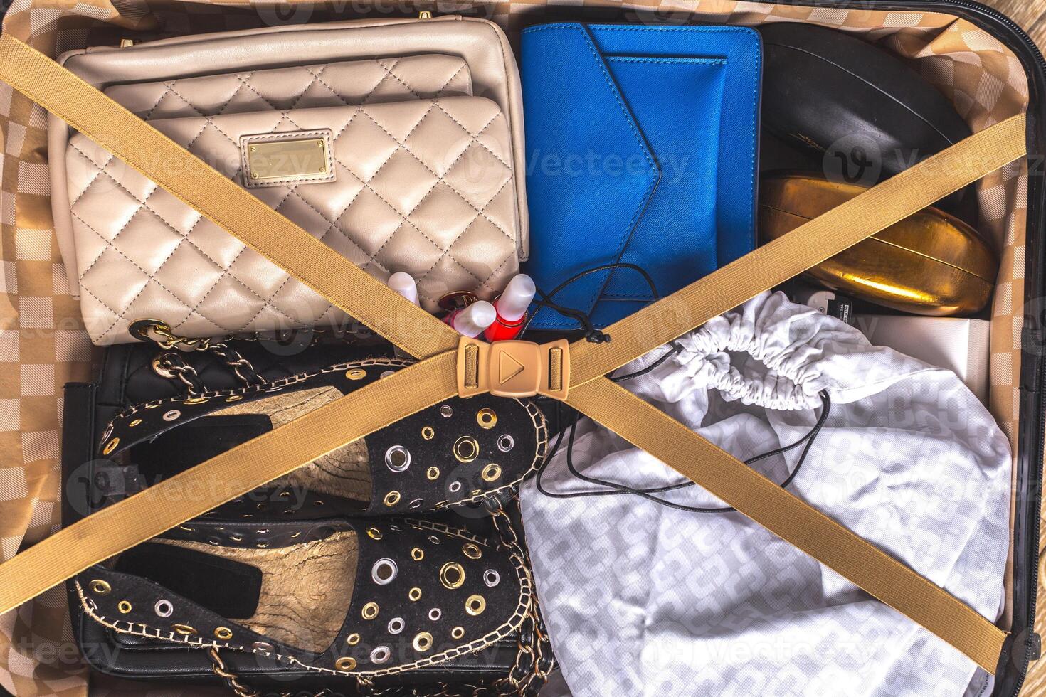 Packed suitcase of vacation items photo