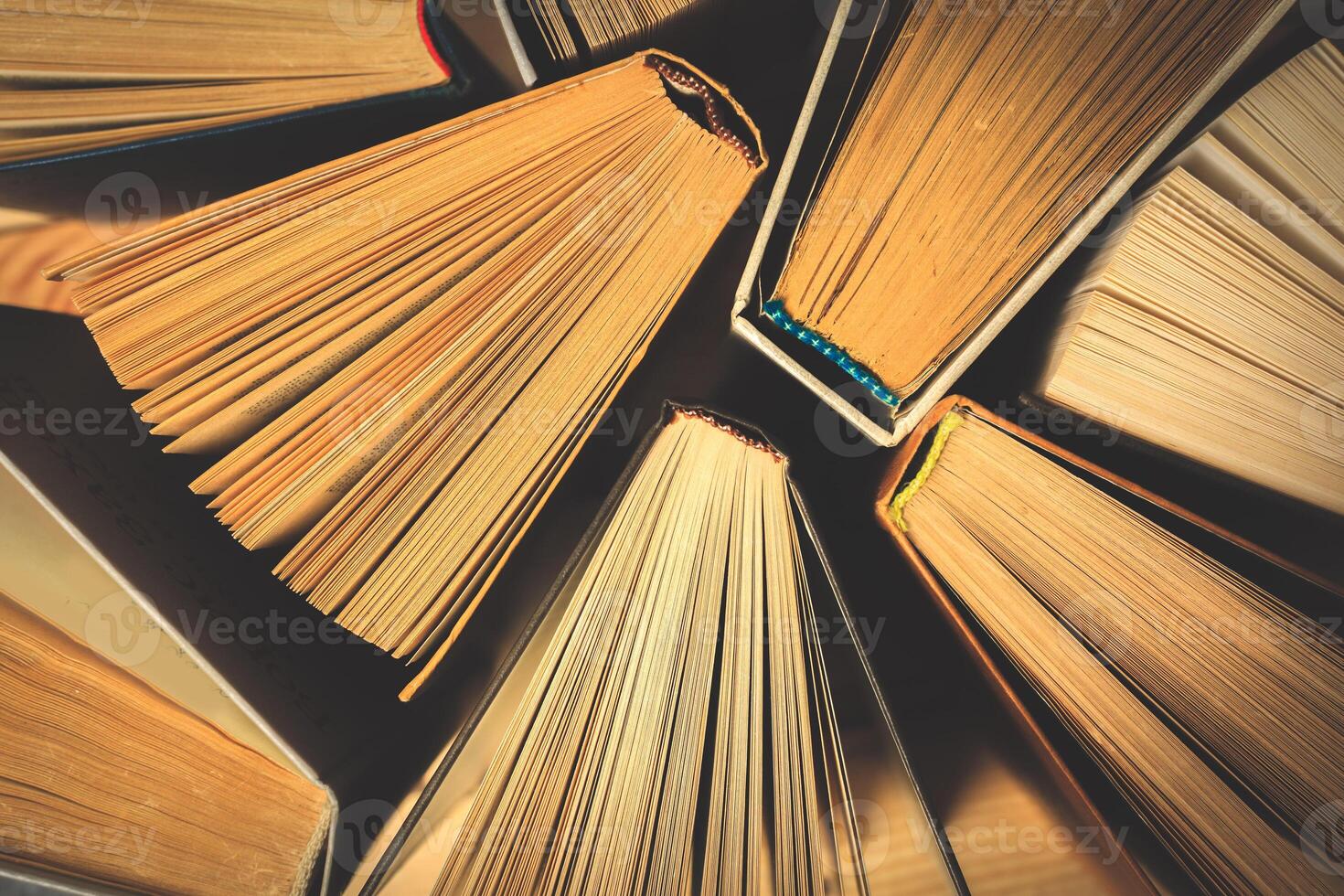 Old and used hardback books or text books seen from above. photo