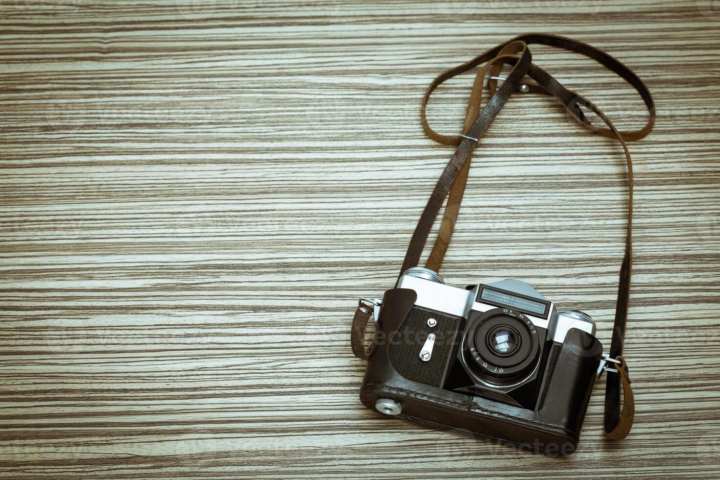 Vintage camera on wooden background photo