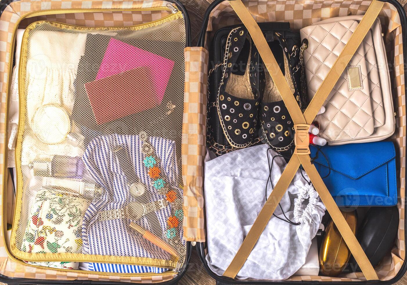 Packed suitcase of vacation items photo