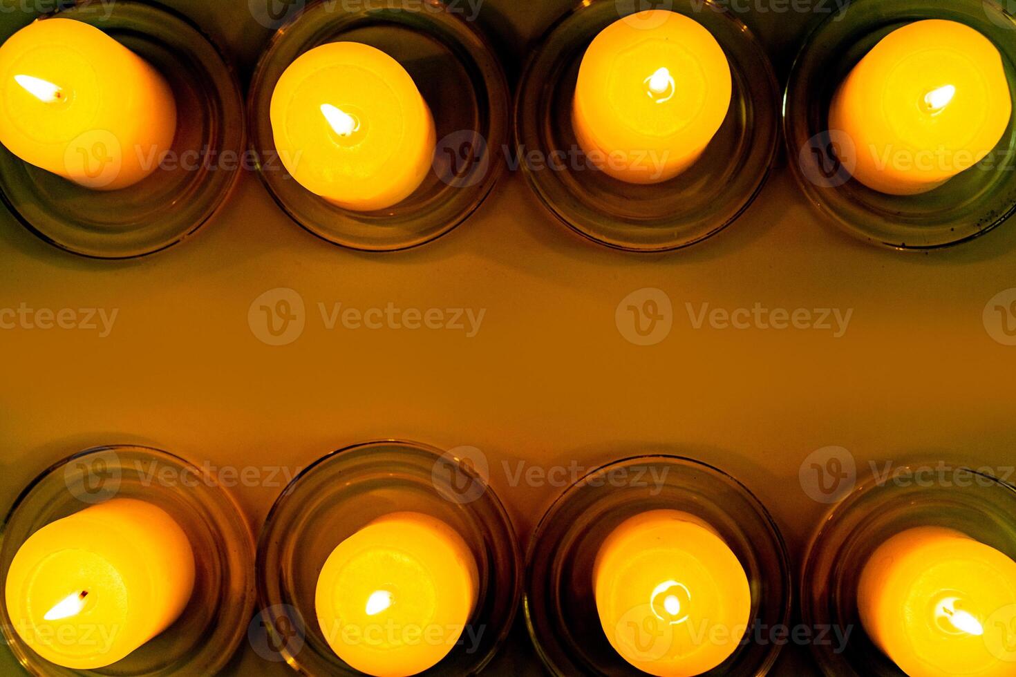 closeup to burning candles in darkness photo