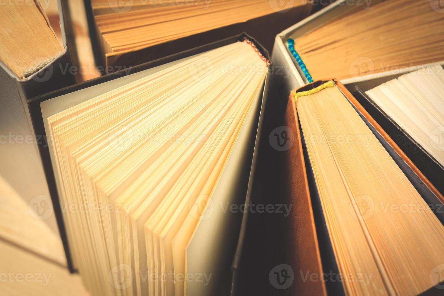 Old and used hardback books or text books seen from above. photo