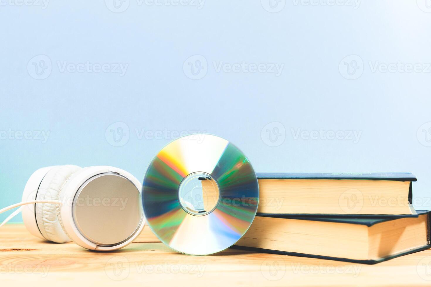 Books on the table with headphones put on them photo