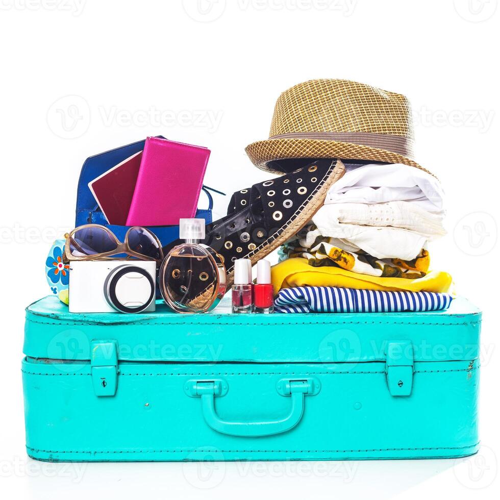 Packing suitcase for trip isolated on white photo