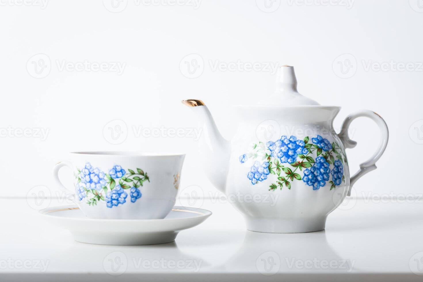 Cup of tea with teapot in vintage style photo