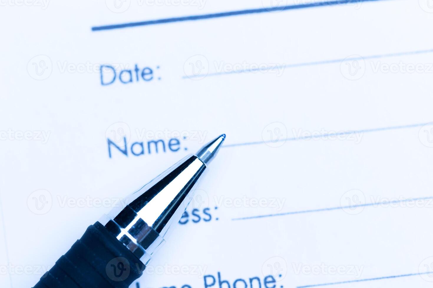 Close-up of pen on contract photo