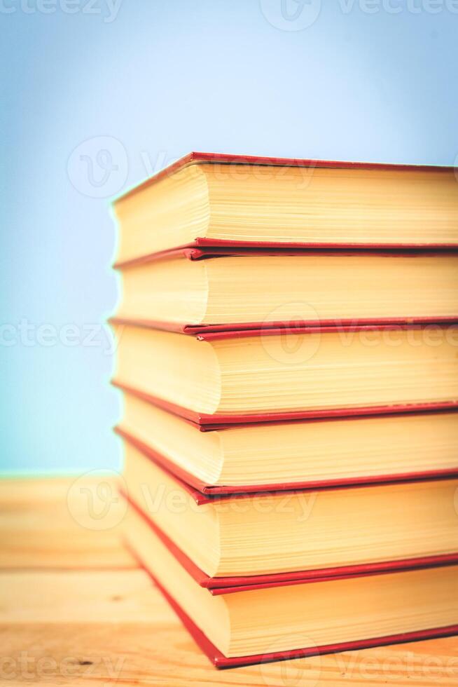 Vintage old books on wooden deck table photo