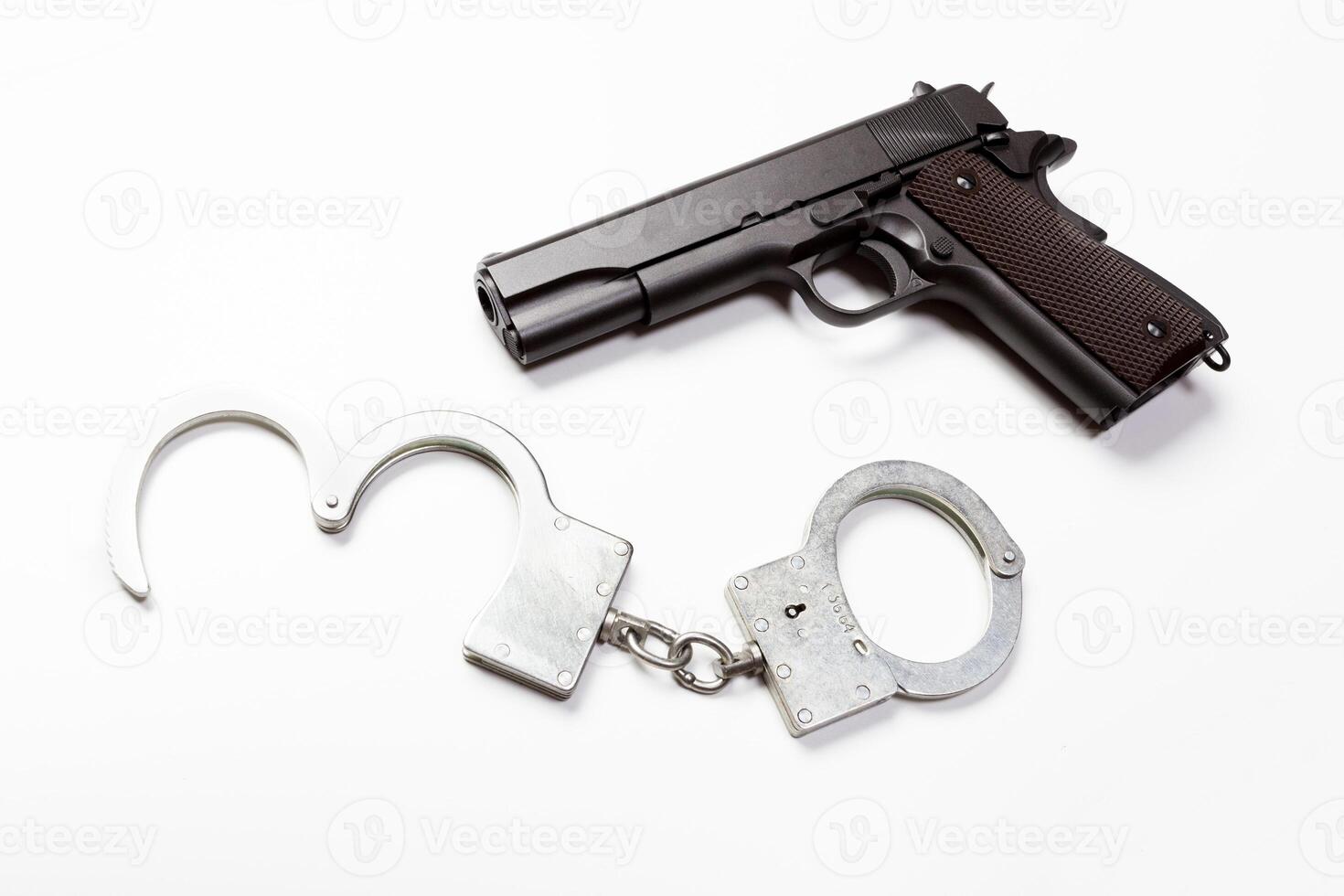 gun and handcuffs on white background photo