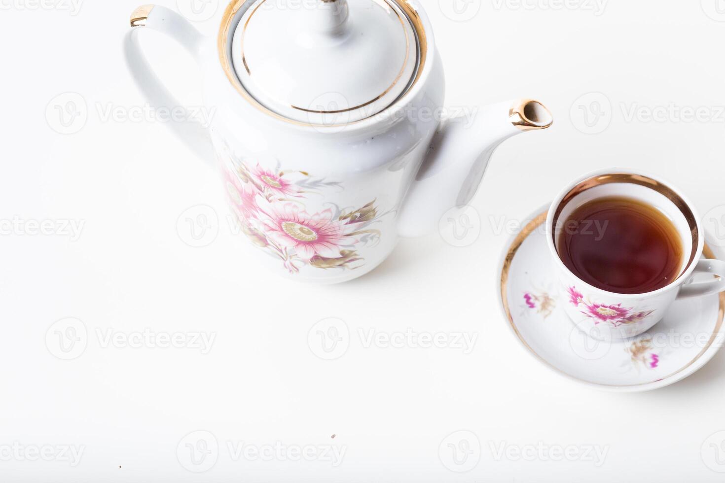 Cup of tea with teapot in vintage style photo